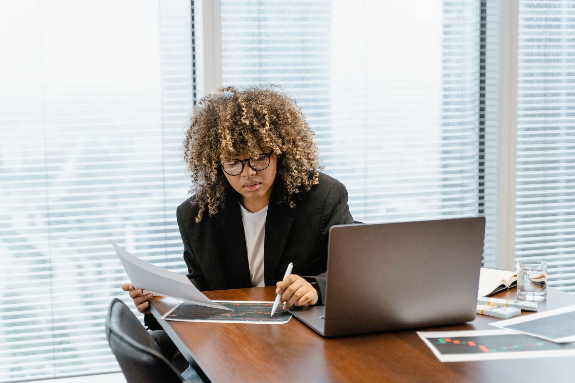 A professional working through business figures on a laptop