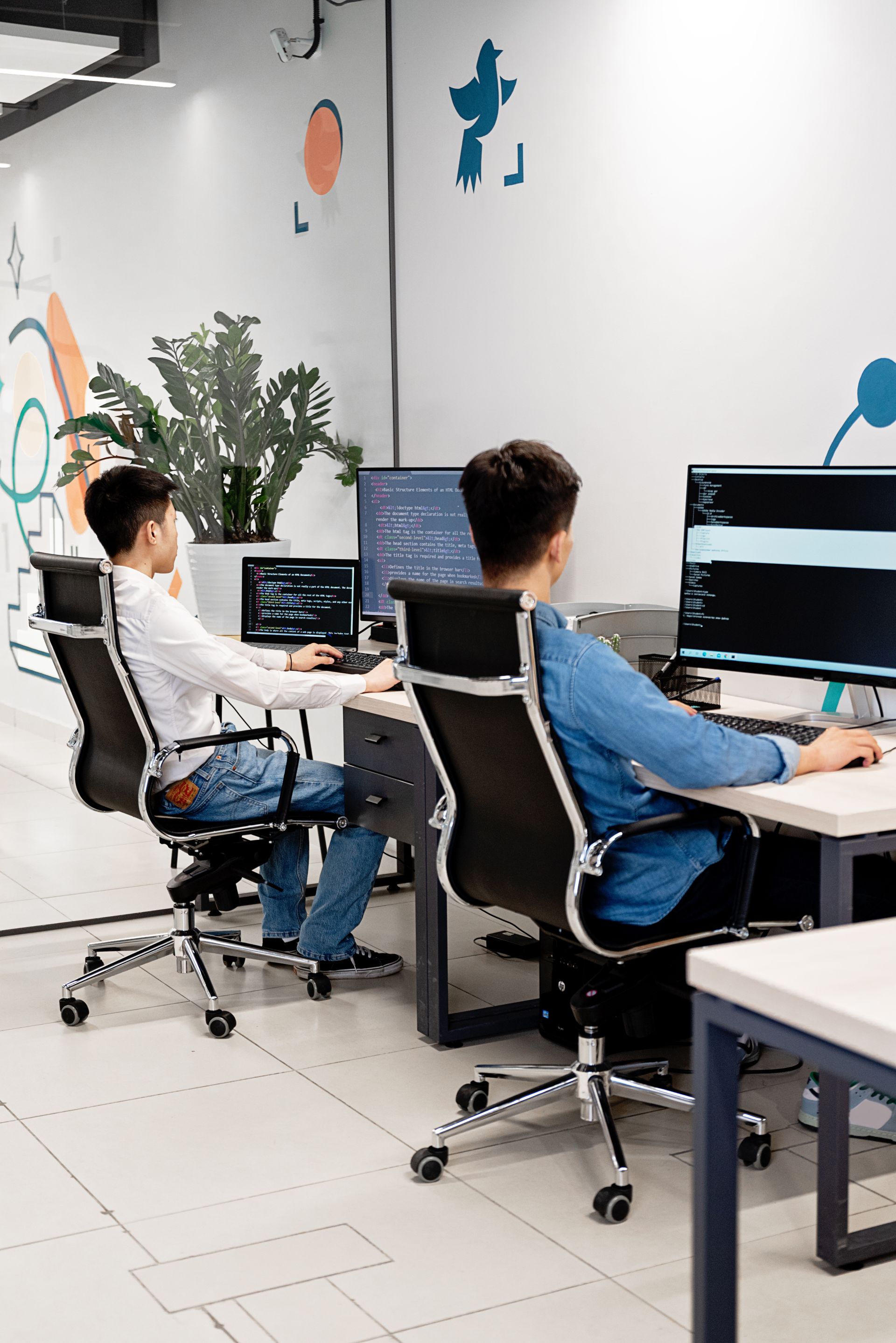 Colleagues working across several screens in one office